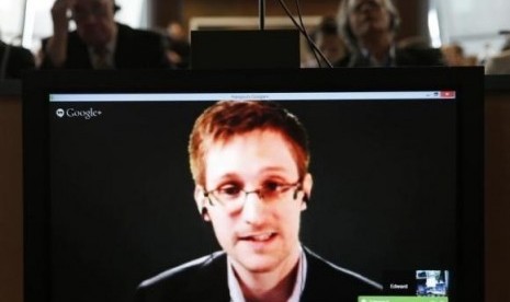 Accused government whistleblower Edward Snowden is seen on a screen on April 8, 2014.