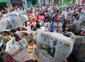 Aksi membaca koran massal berlangsung dalam acara Jalan Sehat Republika.