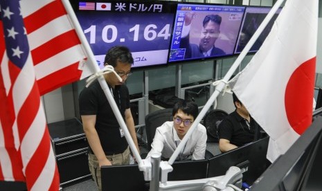 Aktivitas di pasar saham saat sesi perdagangan pagi ketika televisi menayangkan pemimpin Korea Utara Kim Jong-un, di Tokyo, Jepang, Jumat (15/9). Korea Utara meluncurkan rudal balistik atas Jepang yang dilaporkan jatuh di Samudera Pasifik, sekitar 2.000 km di timur Hokkaido, pulau yang terletak di bagian utara Jepang Hokkaido. 