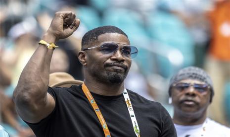 Aktor Jamie Foxx melayangkan kepalannya ke udara saat pertandingan tenis antara atlet Rusia Daniil Medvedev dan petenis Amerika Serikat, Christopher Eubanks, di perempat final Miami Open 2023 di Hard Rock Stadium, Miami, Florida, AS, 30 Maret 2023. Foxx dikabarkan telah sembuh dari komplikasi medis.