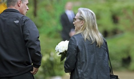 Aktris Merryl Streep tampak membawa seikat bunga saat tiba di rumah duka Debbie Reynolds dan Carrie Fisher, (6/1), di Los Angeles.