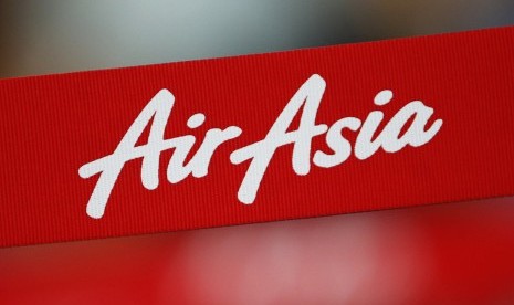 An AirAsia sign is pictured at a check-in counter at Changi Airport in Singapore December 28, 2014. 