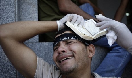 An egyptian grieves for supporter of President Mohammed Mursi, who were killed overnight clashes with security forces in Nasr City, Cairo, Saturday July 27, 2013.