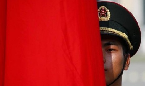 An honour guard member is seen behind a red flag during a welcoming ceremony for Kuwait's Prime Minister Sheikh Jaber al-Mubarak al-Sabah at the Great Hall of the People in Beijing, June 3, 2014.