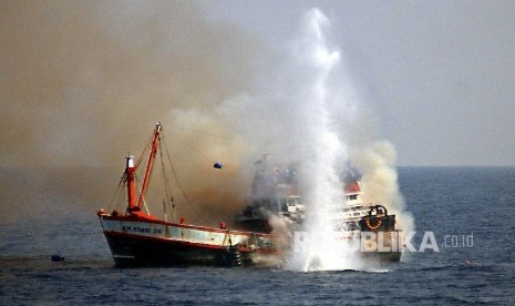   An Indonesian navy ship sinks a fishing boat from Thailand off the coast of Surabaya on November 14, 2003 after it was seized for fishing in Indonesian waters without a permit. The Indonesian navy, on a routine patrol two days ago, seized the boat and arrested 18 Thai fishermen for illegal fishing