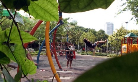 Anak-anak bermain ayunan di Taman Mentrng Jakarta, Kamis (10/12).