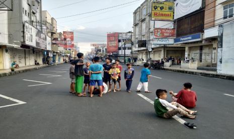 Anak-anak bermain bola di kawasan pusat pertokoan Jalan KHZ Mustofa, Kota Tasikmalaya, Rabu (21/7). Jalan itu merupakan salah satu yang ditutup oleh Satgas Penanganan Covid-19 Kota Tasikmalaya selama PPKM Darurat.