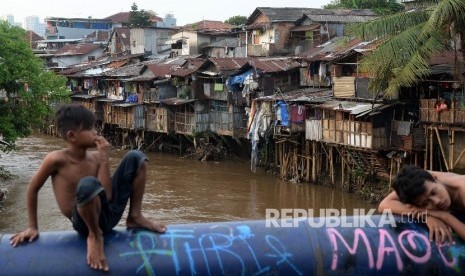 Anak-anak bermain di pinggirian Sungai Ciliwung di kawasan Kampung Berlan, Jakarta, Selasa (15/3). 