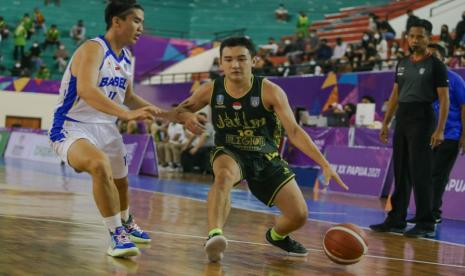  Andreas Marcellino Bonfillio (kanan) asal Jawa Timur berhadapan dengan Fransiscus Bryan Prasetio asal Bangka Belitung pada laga penyisihan grup basket putra di GOR Sport Centre, Timika, Kabupaten Mimika, Papua, Senin (4/10).