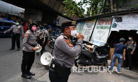 Anggota Ditsamapta Polda Metro Jaya melakukan sosialisasi protokol kesehatan di Pasar Pagi Asemka, Jakarta Barat, Rabu (27/5/2020). Sosialisasi protokol kesehatan di sektor niaga tersebut untuk menuju tatanan normal baru sehingga masyarakat dapat dan terbiasa menjalankan protokol yang telah ditetapkan pemerintah.