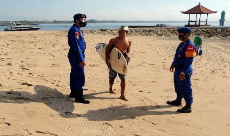 Anggota Sat Pol Air Polresta Denpasar menegur warga yang tidak menggunakan masker saat berpatroli pada Pemberlakuan Pembatasan Kegiatan Masyarakat (PPKM) Level 4 di Pantai Sanur, Denpasar, Bali, Kamis (26/8/2021). Berdasarkan data secara kumulatif Satgas Penanganan COVID-19 Kota Denpasar dari tanggal 1 - 25 Agustus 2021 terkonfirmasi kasus positif COVID-19 berjumlah 8.879 orang, angka kesembuhan 11.781 orang, meninggal dunia 285 orang dan kasus aktif yang masih dalam perawatan sebanyak 2.447 orang.