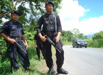 Aparat keamanan dari Sat Brimob Polda Papua berjaga di lokasi peristiwa penembakan yang dilakukan oleh orang tak dikenal yang menewaskan tiga warga sipil dan satu anggota TNI, di Kampung Nafri, Jayapura, Papua.