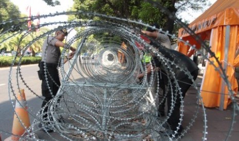 Aparat kepolisian memasang pagar kawat berduri di kantor Komisi Pemilihan Umum (KPU), Jakarta, Sabtu (29/6/2019). KPU akan melakukan rapat pleno terbuka penetapan pasangan calon presiden dan wakil presiden terpilih Pemilu 2019 pada Ahad (30/6/2019). 