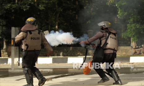 Aparat kepolisian menembakan gas air mata ke arah kerumunan mahasiswa Universitas Haluoleo Kendari saat unjuk rasa menuntut penuntasan kasus kematian dua mahasiswa di depan Markas Polda Sulawesi Tenggara, Kendari, Sulawesi Tenggara, Sabtu (26/9/2020). Mahasiswa meminta kepada kepolisian untuk mengusut dan menuntaskan kasus kematian Randi dan Muhammad Yusuf Kardawi yang meninggal dunia diduga ditembak saat aksi penolakan RKUHP dan RUU Kontroversial pada 26 September 2019 lalu. 