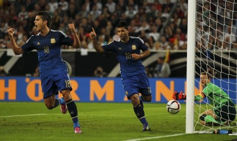 Argentina's Erik Lamela reacts next to team mate Sergio Aguero (R) after Aguero scored a goal against Germany's goalkeeper Manuel Neuer (R) during their friendly soccer match in Duesseldorf September 3, 2014.