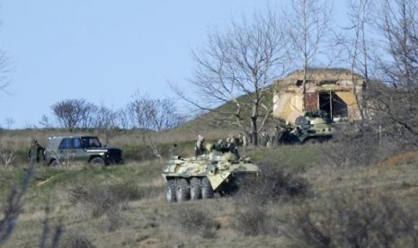 Armed men, believed to be Russian servicemen, gather on a hill near a military base in the Crimean town of Belbek outside Sevastopol March 22, 2014. 