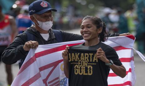 Atlet DKI Jakarta Odekta Elvina Naibaho (kanan) bersama pelatihnya Wita Witarsa berselebrasi usai mencapai garis finish dalam nomor lari maraton putrI PON Papua di kompleks Freeport, Kuala Kencana, Kabupaten Mimika, Papua, Sabtu (9/10/2021). Odekta berhasil meraih medali emas, sementara atlet DKI lainnya Tryaningsih meraih medali perak dan atlet Kalimantan Timur Irma Handayani meraih medali perunggu.