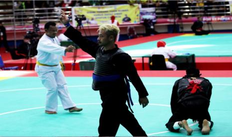 Atlet pencak silat dari Jawa Barat, Hanifan Yudani Kusumah (biru) berhasil mengalahkan Riki Aris Muandar (merah) dari Sulawesi Tenggara pada cabor Pencak Silat PON XX Papua di GOR Toware, Jayapura, Sabtu (9/10).