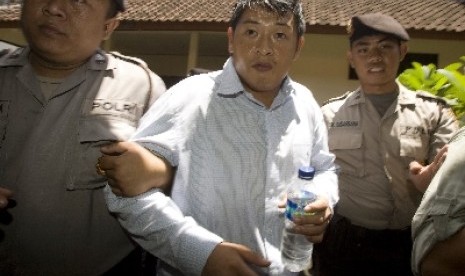 Australian death-row prisoner Andrew Chan, center, is escorted by Indonesian police officers at Denpasar district court before a trial hearing in Bali, Indonesia.