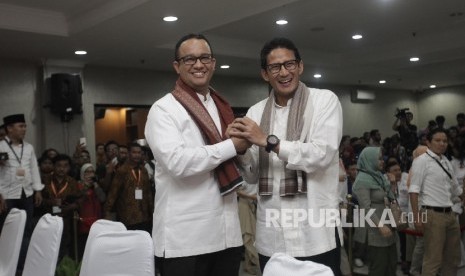 Bakal Calon Gubernur DKI Anies Baswedan (kiri) bersalaman dengan Bakal Cawagub Sandiaga Uno (kanan) sebelum menyerahkan dokumen pendaftaran kepada pimpinan KPUD DKI saat di KPUD DKI Jakarta, Jumat (23/9) malam.