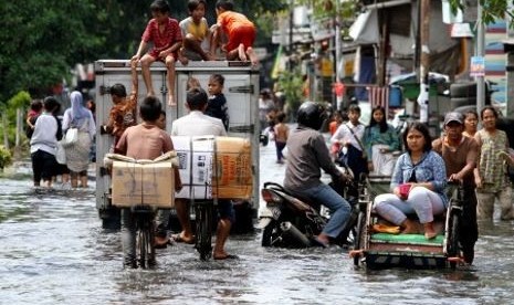 Banjir rob di Mangga Dua akibat limpasan air laut menggangu aktivitas warga.