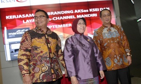 Dirut KSEI Heri Sunaryadi (kiri) dan Direktur Treasury, Financial Institutions and Special Asset Management Bank Mandiri Royke Tumilaar (kanan) serta disaksikan Kepala Eksekutif Pengawas OJK Nurhaida di Jakarta, Senin (1/9). (Foto: Yasin Habibi/ Republika)