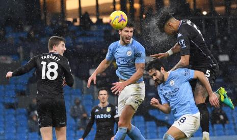 Bek Manchester City John Stones berebut bola atas dengan para pemain Aston Villa.