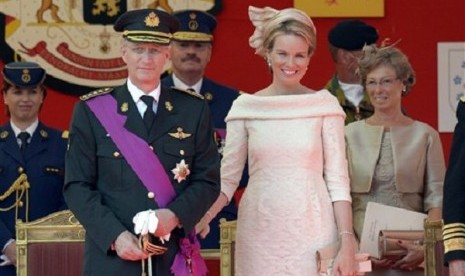 Belgium's King Philippe (second left) and Queen Mathilde review the troops during a military parade in Brussels on Sunday, July 21, 2013. 