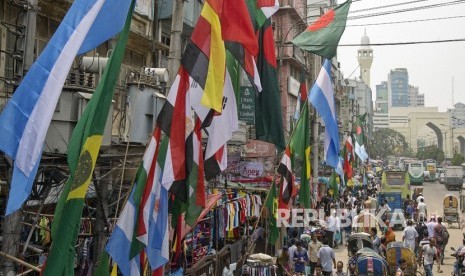 Bendera negara-negara peserta Piala Dunia  2018 serta bendera nasional Bangladesh dipajang di kios pedagang kaki lima di Dhaka, Bangladesh (7/6).