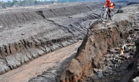 BERSEPEDA DI KALI GENDOL. Seorang anggota Journalist MTB peserta Tour de Merapi Garuda Indonesia melaju di atas material lahar dingin yang menutupi Sungai Gendol, Cangkringan, Yogyakarta, Sabtu (23/4). Sungai Gendol yang tertutup material vulkanik akibat e