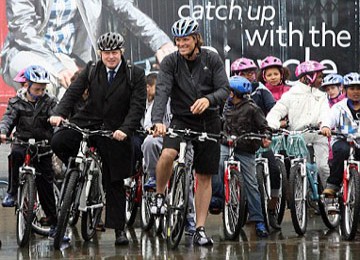 Boris Johnson bersepeda dengan peraih medali emas Olimpiade James Cracknell dan sekelompok anak sekolah di Trafalgar Square