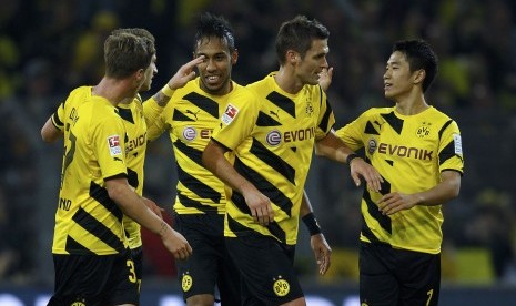 Borussia Dortmund players celebrate an owngoal by Borussia Moenchengladbach during the Bundesliga first division soccer match in Dortmund November 9, 2014