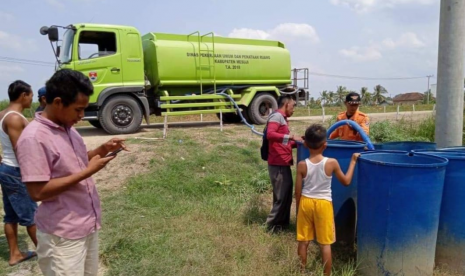 BPBD Kabupaten Mesuji, Lampung, mendistribusikan air bersih di Desa Sumber Makmur, Kecamatan Mesuji, Senin (26/8). 