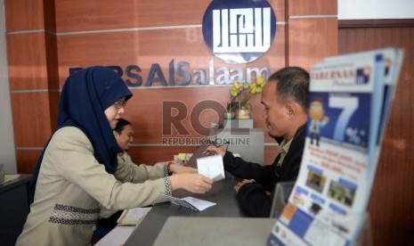 BPRS Satu Kompartemen: Karyawan melayani nasabah di Bank Perkreditan Rakyat Syariah (BPRS) Al Salaam, Jakarta, Rabu (22/4). (Republika/ Yasin Habibi.)