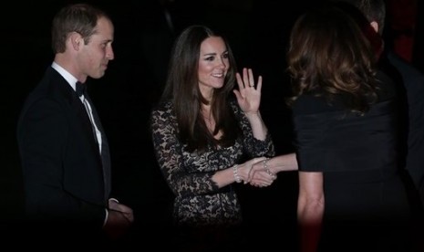 Britain's Duke of Cambridge Prince William (left) and Kate Middleton the Duchess of Cambridge (center) arrive at the Natural History Museum in London, on Dec. 11, 2013. 