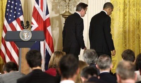 Britain's Prime Minister David Cameron (left) and US President Barack Obama (right) depart after a joint news conference in the East Room at the White House in Washington, May 13, 2013. 