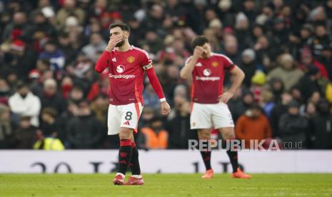 Bruno Fernandes, kiri, dan Harry Maguire dari Manchester United bereaksi setelah Brighton mencetak gol ketiga bagi timnya selama pertandingan sepak bola Liga Primer Inggris antara Manchester United dan Brighton dan Hove Albion, di stadion Old Trafford di Manchester, Inggris, Minggu, 19 Januari 2025.