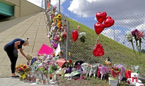 Bunga, balon-balon dan boneka di Marjory Stoneman Douglas High School di Parkland, Florida menjadi simbol untuk mengingat korban penembakan di sekolah tersebut, Ahad (18/2).