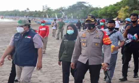 Bupati Pangandaran, Jeje Wiradinata (kiri) dan Kapolres Ciamis, AKBP Donny Eka Putra (kanan) menyisir kawasan Pantai Pangandaran untuk memberikan imbauan penerapan protokol kesehatan teehadap para wisatawan.