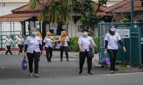 Buruh pabrik berjalan meninggalkan area pabrik pada saat jam pulang kerja di salah satu Pabrik di kawasan Ciracas, Jakarta Timur. Menaker Ida Fauziyah baru saja menerbitkan peraturan yang mengatur jaminan hari tua (JHT) kini baru bisa diambil saat pekerja mencapai usia 56 tahun.