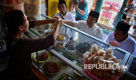  Calon Gubernur DKI Jakarta Anies Baswedan mengunjungi warung tegal (warteg) sekaligus mencicipi langsung makanan di Kelurahan Cabawan, Margadana, Tegal, Jawa Tengah, Rabu (29/3).