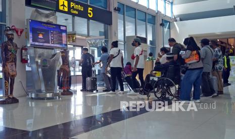 Calon penumpang berjalan menuju pesawat di ruang keberangkatan Bandara Sentani, Jayapura, Papua, Ahad (19/12/2021). Penumpang di Bandara Sentani, Kabupaten Jayapura, Papua, selama Maret 2022 mengalami kenaikan 25 persen dibanding periode yang sama pada 2021.