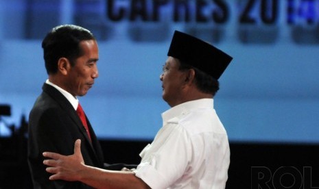 Both presidential candidates, Joko Widodo (left) and Prabowo Subianto hug each other during their presidential debate in Jakarta on Sunday.