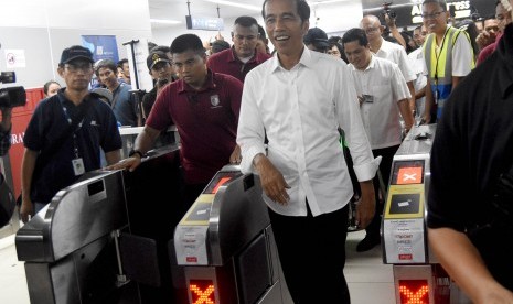 Calon Presiden petahana nomor urut 01 Joko Widodo (kanan) bersiap menaiki kereta Mass Rapid Transit (MRT) di Stasiun Bundaran Hotel Indonesia, Jakarta, Sabtu (20/4/2019). 