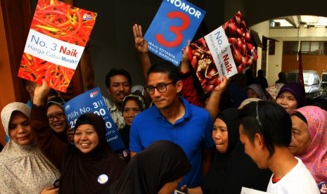 Calon Wakil Gubernur DKI nomer urut 3 Sandiaga Salahuddin Uno (tengah) didampingi pendukungnya saat melakukan kampanye di Kebayoran Lama, Jakarta, Selasa (13/12). 