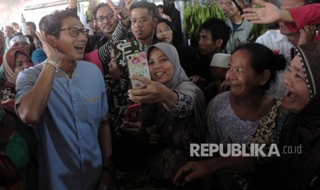 Calon Wakil Presiden nomor urut 02 Sandiaga Uno (kiri) menyapa pedagang dan warga saat berkunjung ke Pasar Modern Angso Duo, Jambi, Jumat (25/1/2019). 