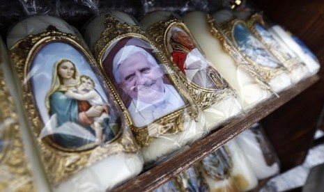 Candles with religious themes and the picture of Pope Benedict are on display near the Graciousnesses chapel on Ash Wednesday in Altoetting February 13, 2013. 