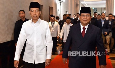 Capres nomor urut 01 Joko Widodo (kiri) berjalan bersama capres no urut 02 Prabowo Subianto sebelum mengikuti Debat Pertama Capres & Cawapres 2019, di Hotel Bidakara, Jakarta, Kamis (17/1/2019).