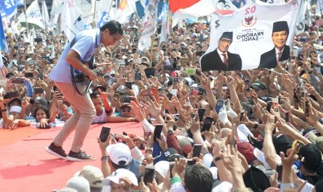 Cawapres nomor urut 02 Sandiaga Uno memainkan gitar saat menghadiri kampanye akbar di Lapangan Ahmad Yani, Alun - Alun Kota Tanggerang, Banten, Sabtu (13/4/2019). 