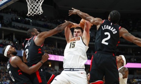 Center Denver Nuggets Nikola Jokic (putih) dijaga para pemain Toronto Raptors.